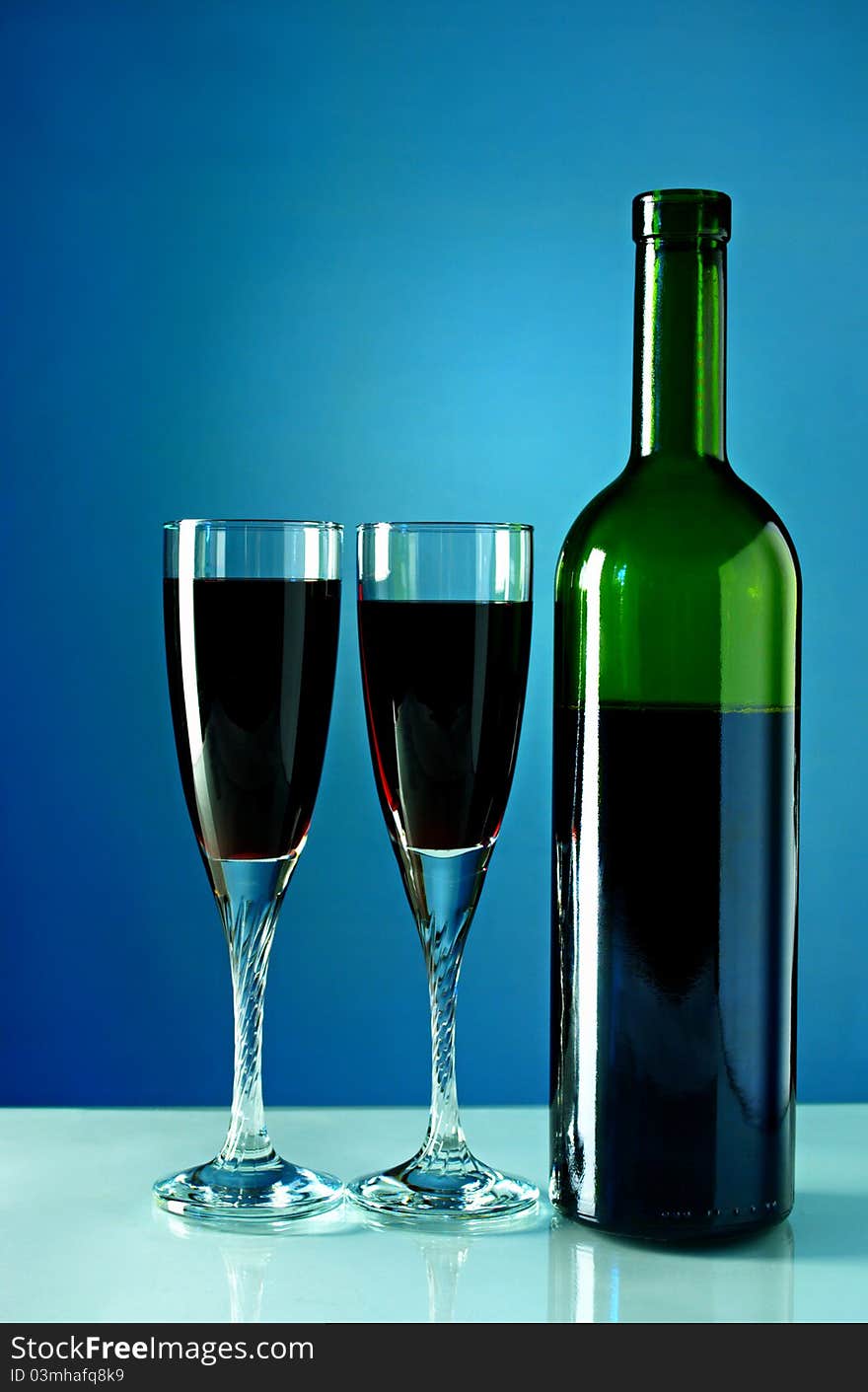 Bottle of wine and two glasses filled with wine. Bottle of wine and two glasses filled with wine