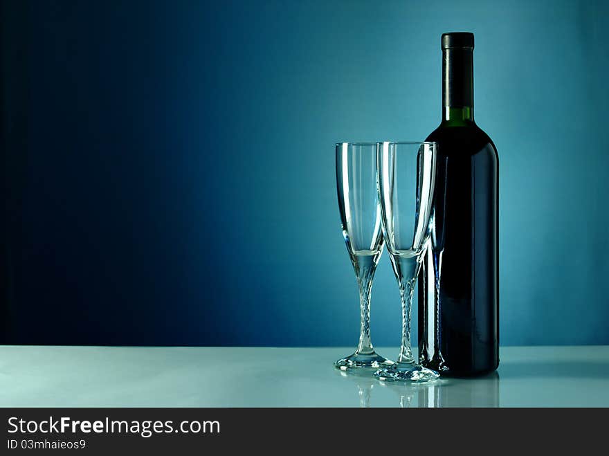 Bottle of wine and two empty glasses. Bottle of wine and two empty glasses