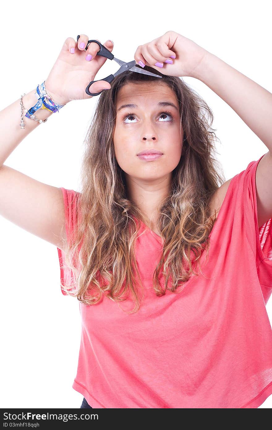 Beautiful woman cutting her hair tips with scissors