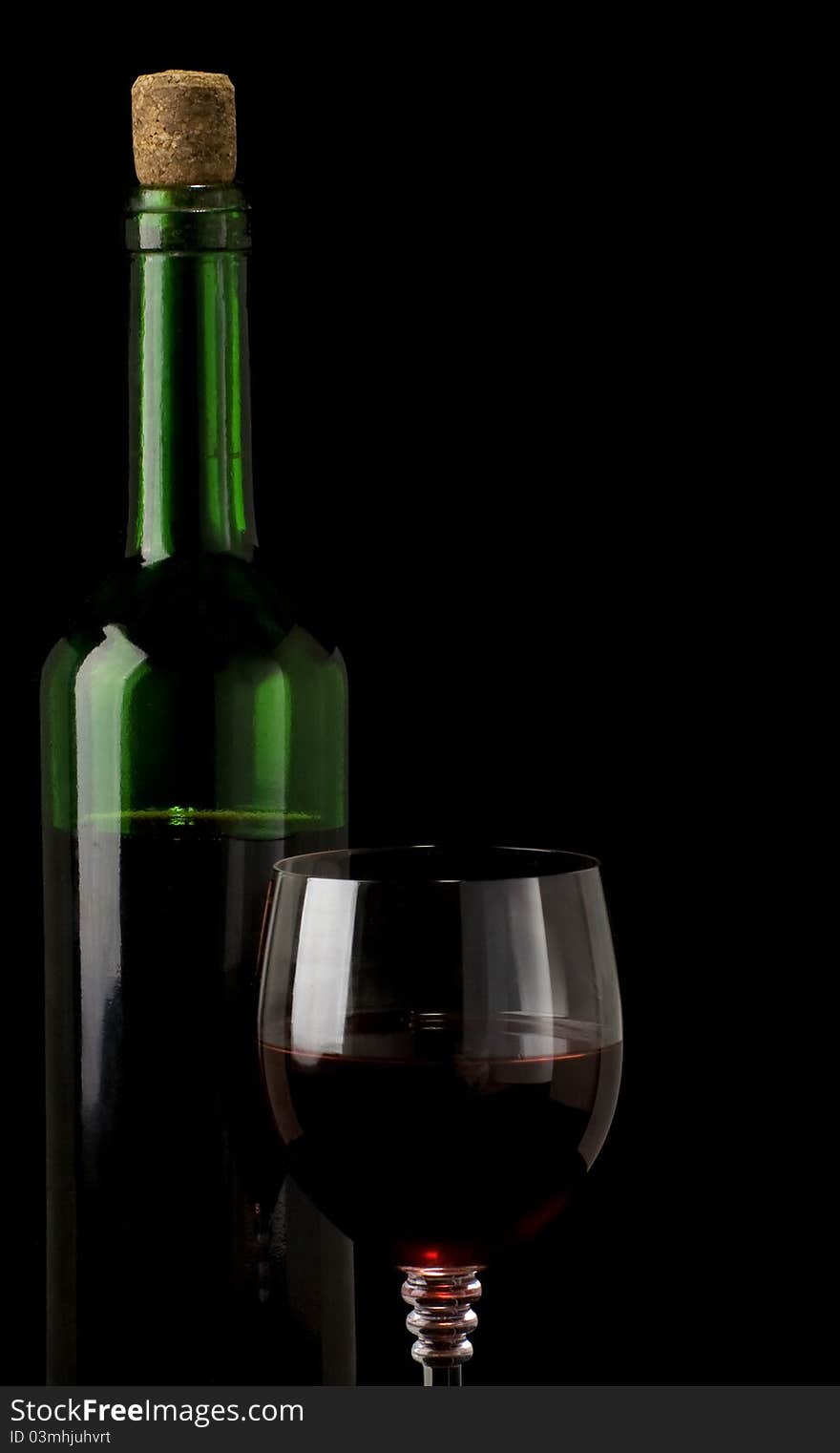 Glass of red wine isolated on black