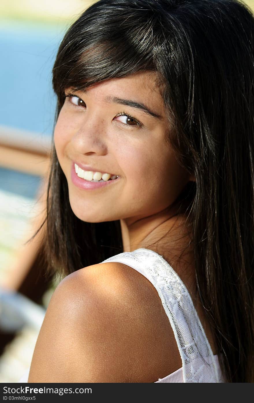 A teen smiling for her portrait. A teen smiling for her portrait.