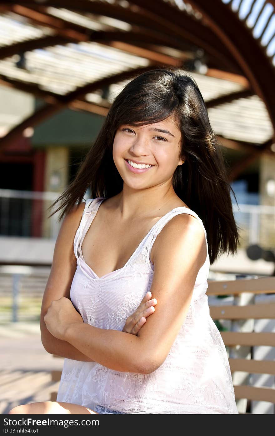 A teen smiling for her portrait. A teen smiling for her portrait.