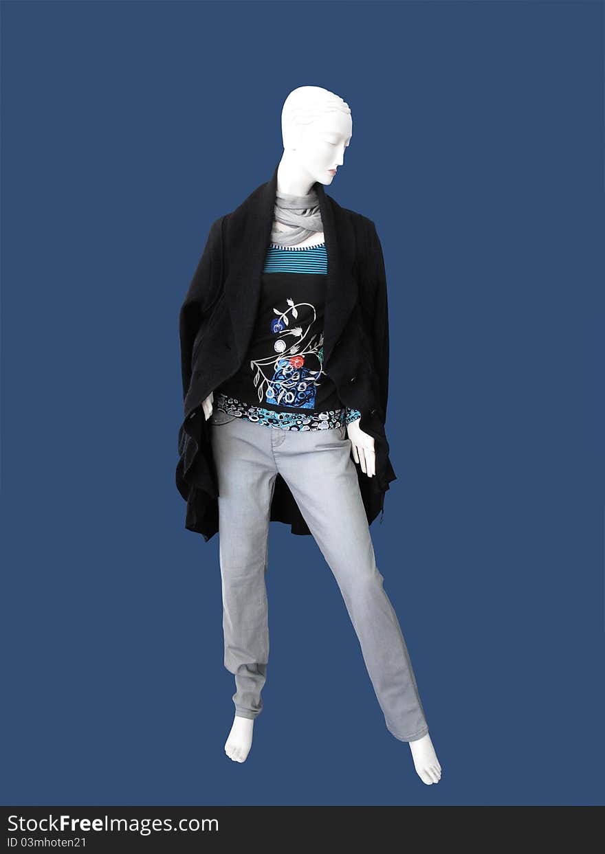 Mannequin in a black coat, gray scarf and jeans. Mannequin in a black coat, gray scarf and jeans