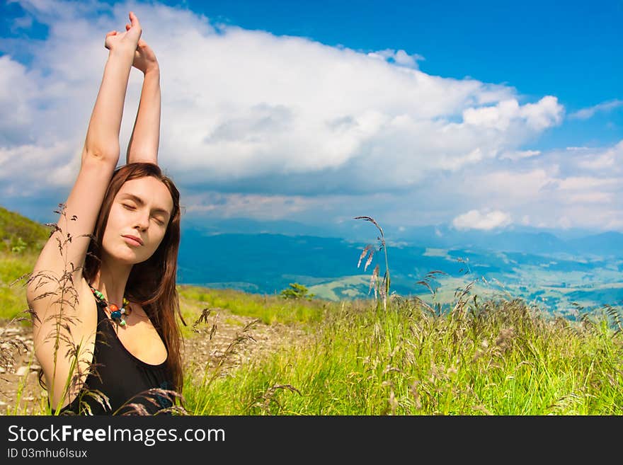 Beautiful young woman under blue sky. Portrait