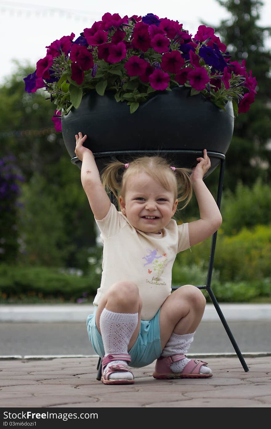 The small child with flowers in the park