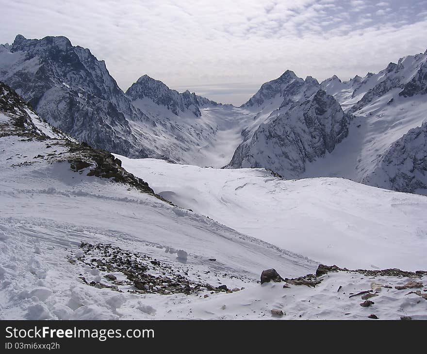 Morning in the snowy mountains, clouds in the sky. Morning in the snowy mountains, clouds in the sky