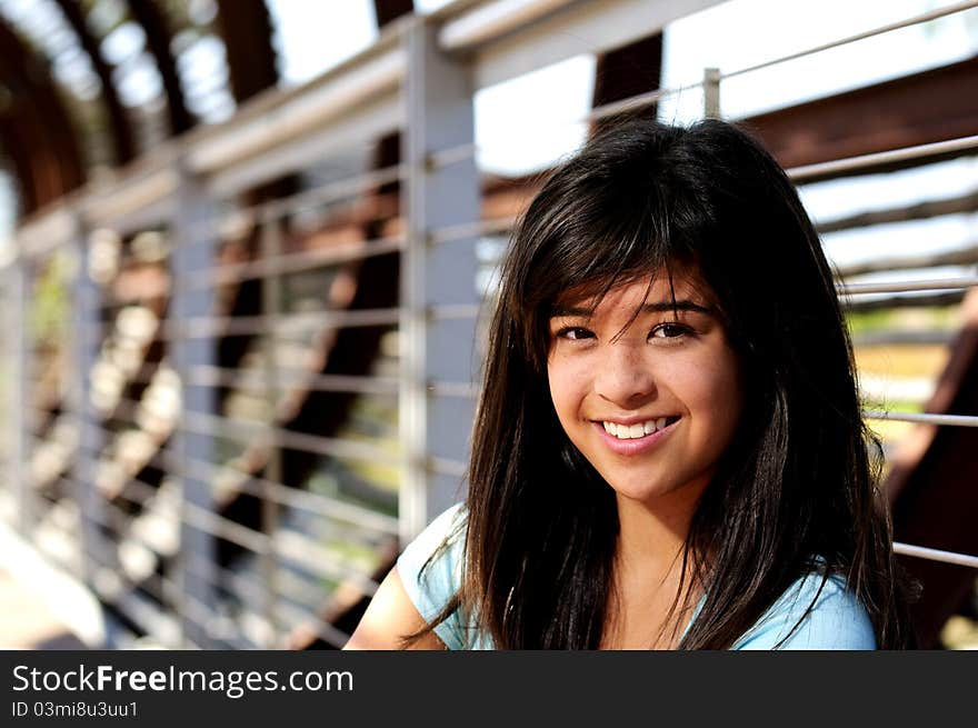 A teen smiling for her portrait. A teen smiling for her portrait.