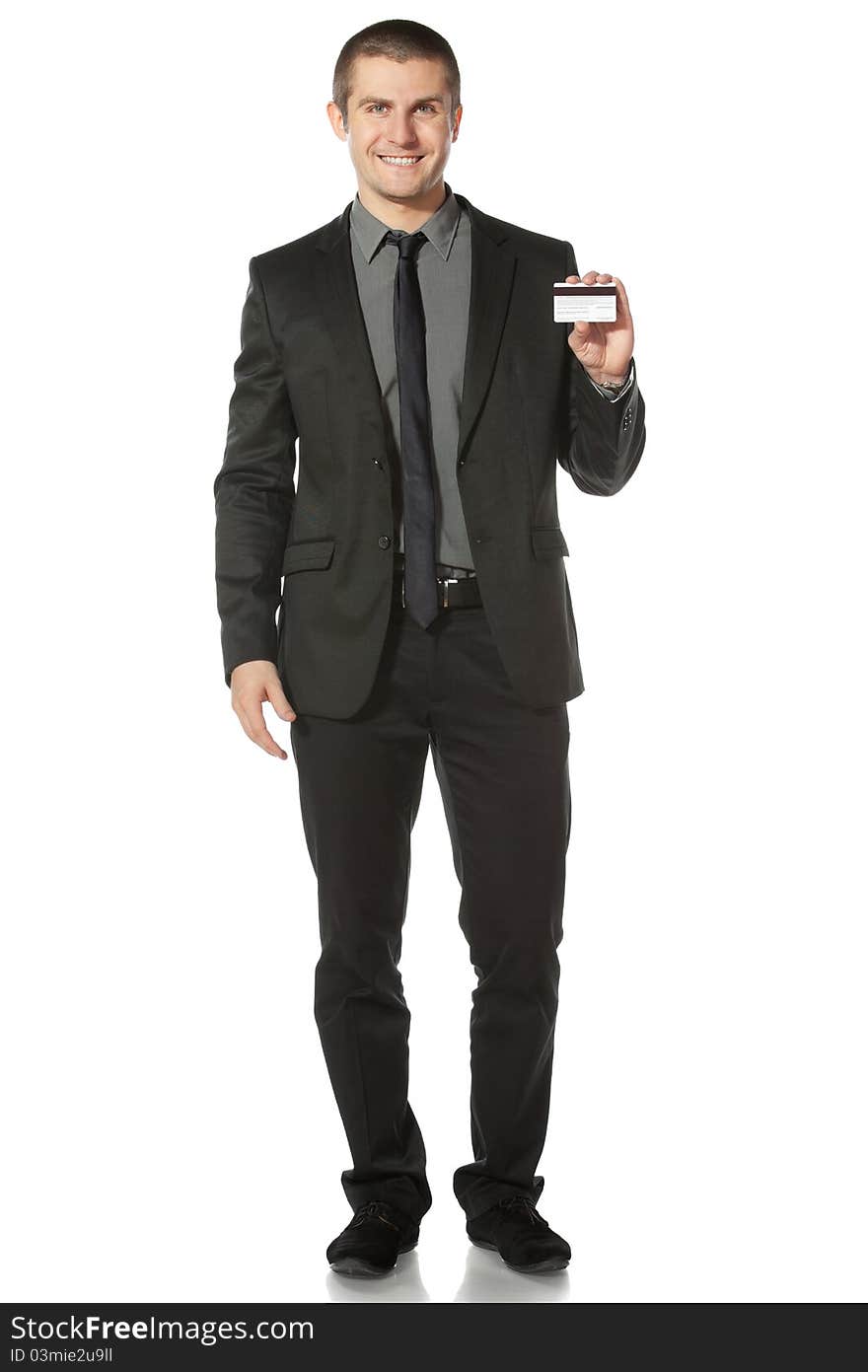 Young smiling businessman holding credit card, on white background. Young smiling businessman holding credit card, on white background