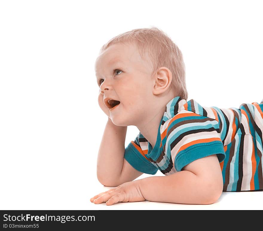 Portrait of a happy 2 year boy lying on a floor on a white background. Portrait of a happy 2 year boy lying on a floor on a white background.