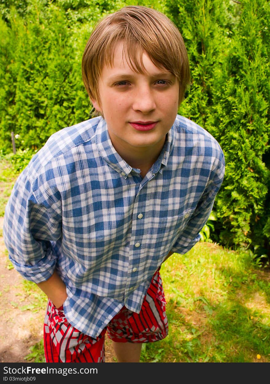 Portrait of teenage boy on the trees background