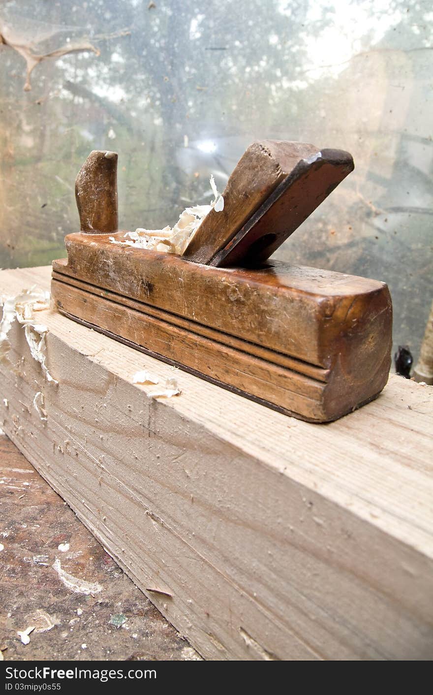 Old cabinetmaker on wood with wood chippings. Old cabinetmaker on wood with wood chippings