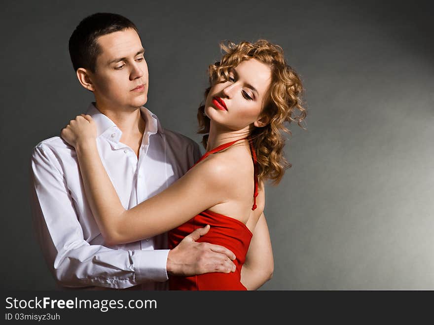 Young Handsome Couple In Elegant Evening Dresses