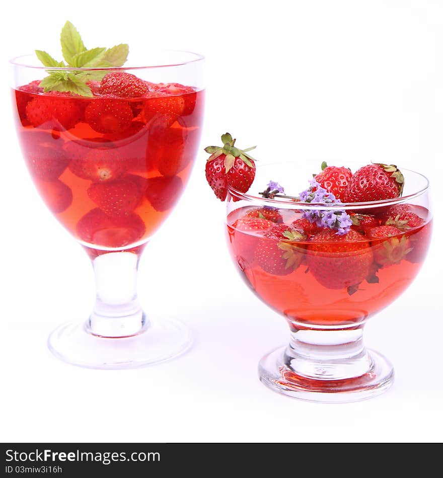 Jelly with strawberries in glass cups on white background. Jelly with strawberries in glass cups on white background