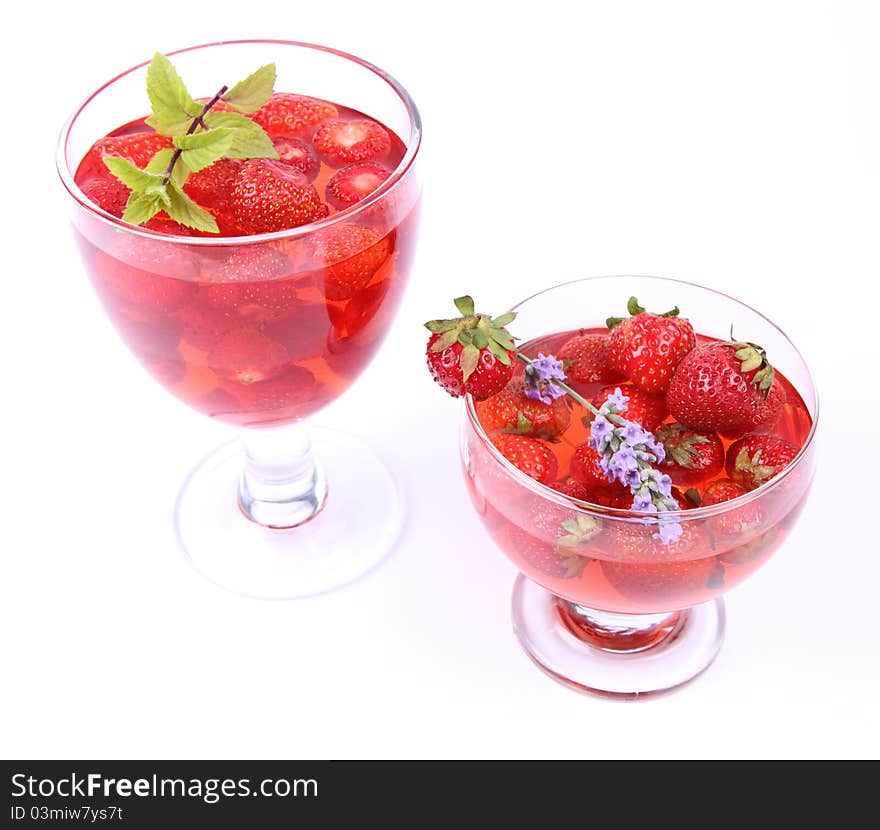 Jelly with strawberries in glass cups on white background. Jelly with strawberries in glass cups on white background