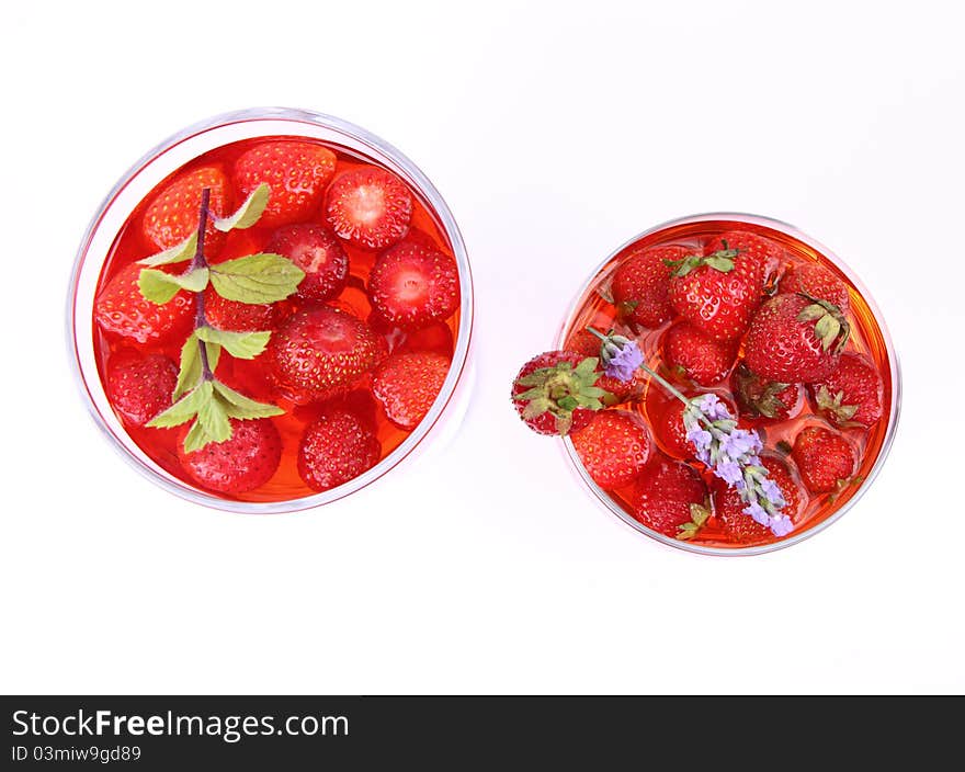 Jelly with strawberries in glass cups on white background. Jelly with strawberries in glass cups on white background