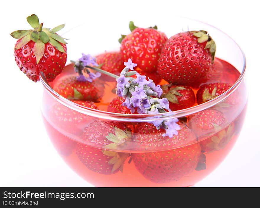 Jelly with strawberries decorated with a lavender twig in a glass cup. Jelly with strawberries decorated with a lavender twig in a glass cup