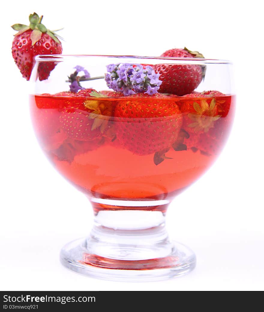 Jelly with strawberries decorated with a lavender twig in a glass cup. Jelly with strawberries decorated with a lavender twig in a glass cup