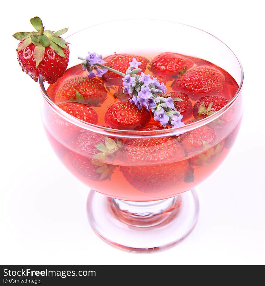 Jelly with strawberries decorated with a lavender twig in a glass cup. Jelly with strawberries decorated with a lavender twig in a glass cup