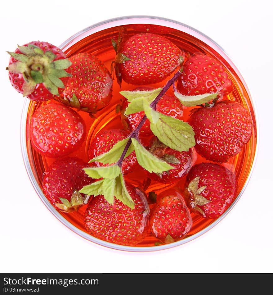 Jelly with strawberries decorated with a mint twig in a glass cup. Jelly with strawberries decorated with a mint twig in a glass cup