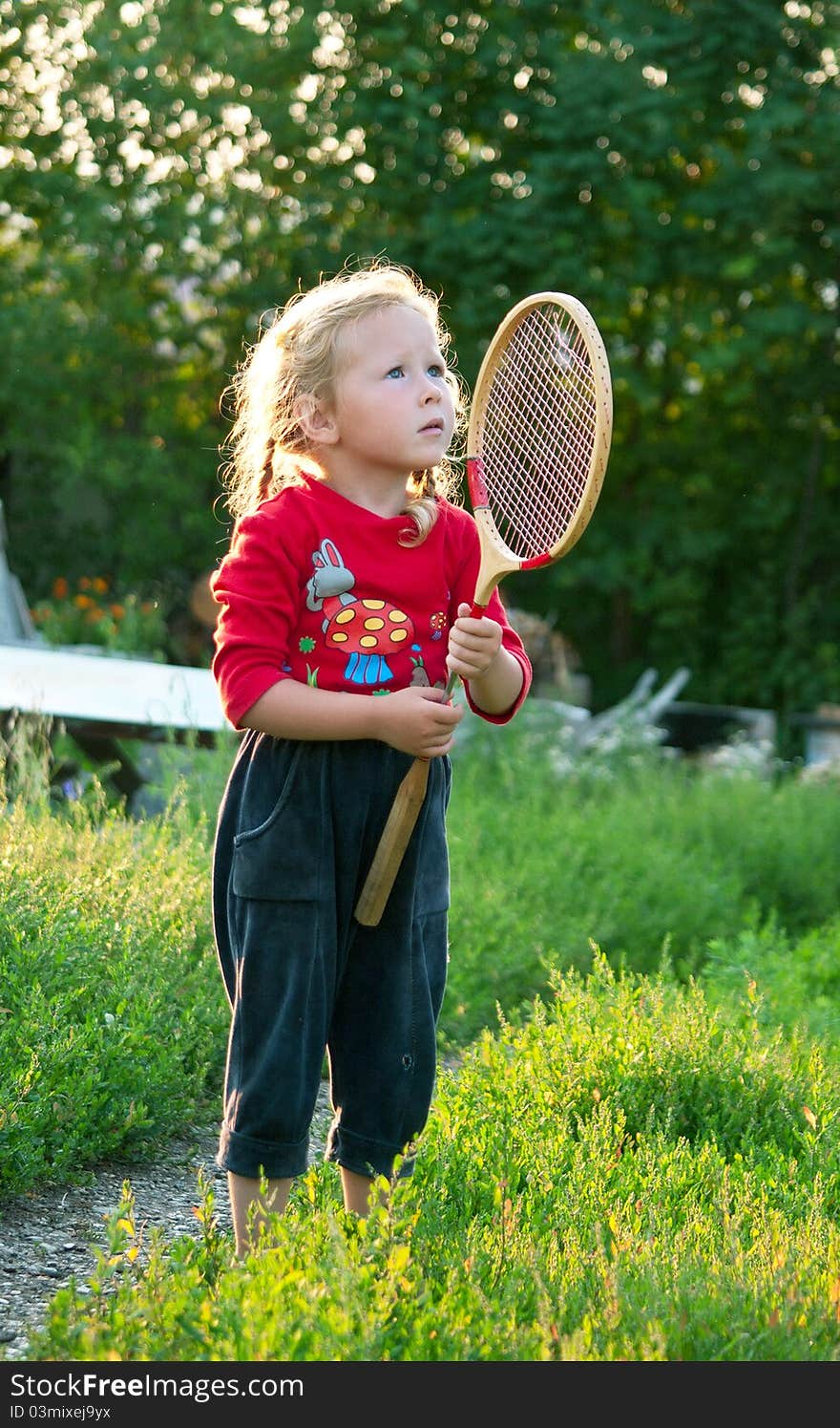 The little girl plays with a racket in badminton. Shallow DOF