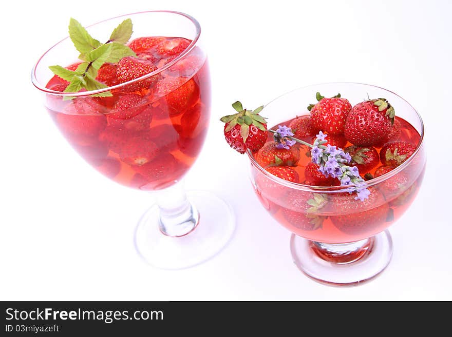 Jelly with strawberries in glass cups on white background. Jelly with strawberries in glass cups on white background