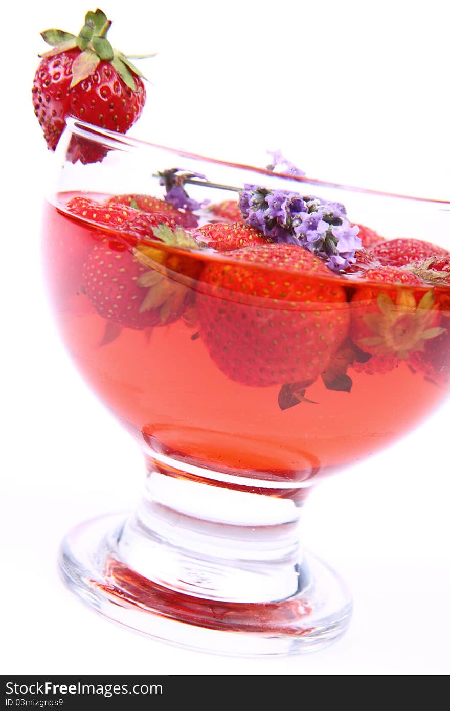 Jelly with strawberries decorated with a lavender twig in a glass cup. Jelly with strawberries decorated with a lavender twig in a glass cup