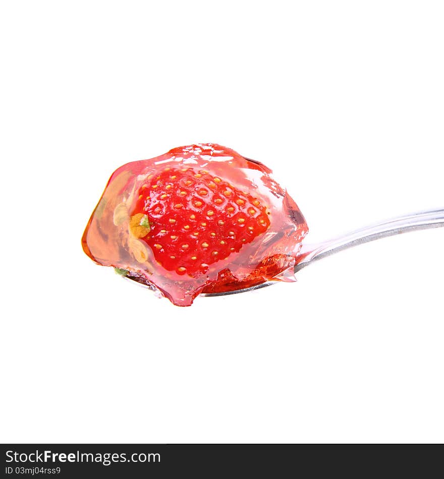 Jelly with a strawberry on a spoon on white background. Jelly with a strawberry on a spoon on white background