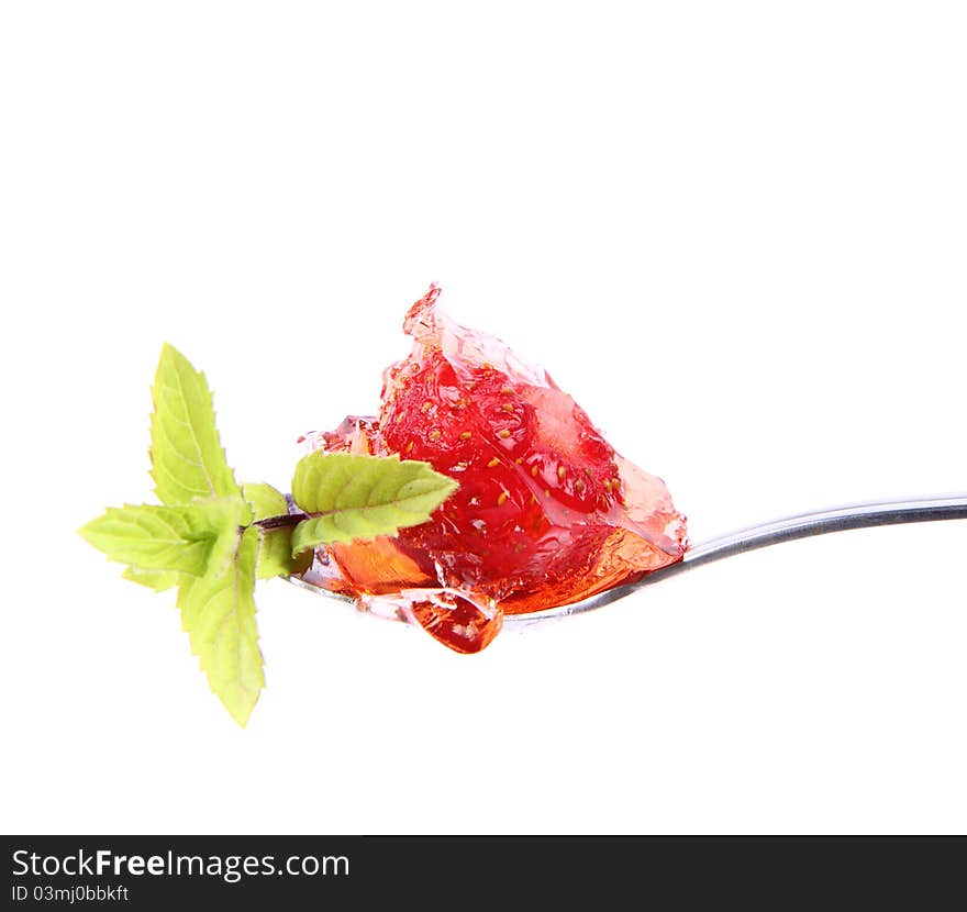 Piece of Strawberry Tart on a fork decorated with mint twig. Piece of Strawberry Tart on a fork decorated with mint twig