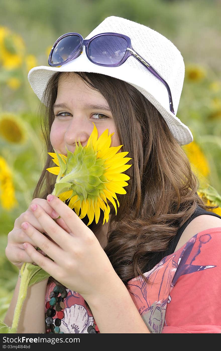 Beauty teen girl and sunflowers in summer time