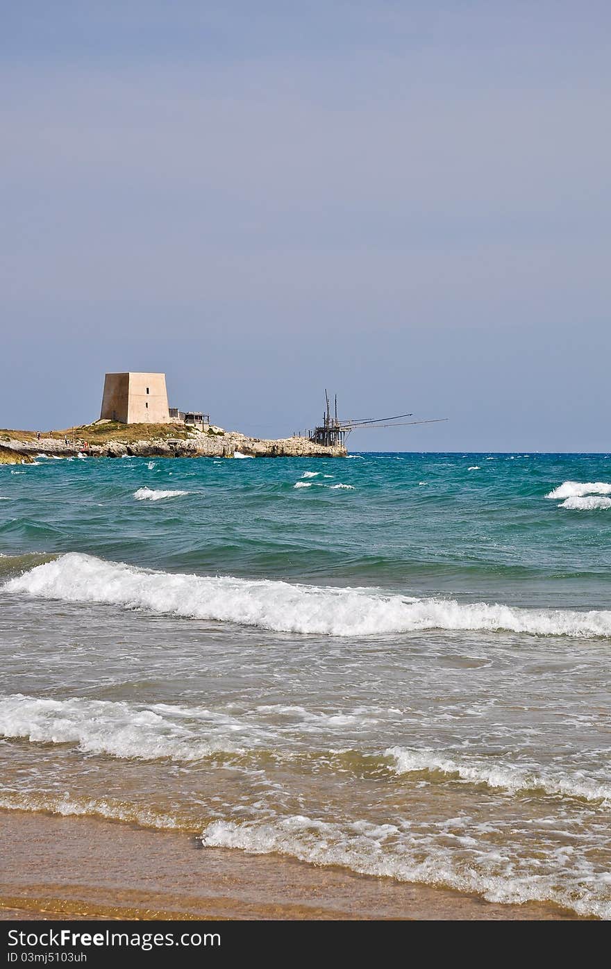 Bay of Manacore, near Peschici, with an ancient Torre Saracena, typical lookout tower of the coast of Gargano. Apulia. Italy. Bay of Manacore, near Peschici, with an ancient Torre Saracena, typical lookout tower of the coast of Gargano. Apulia. Italy.