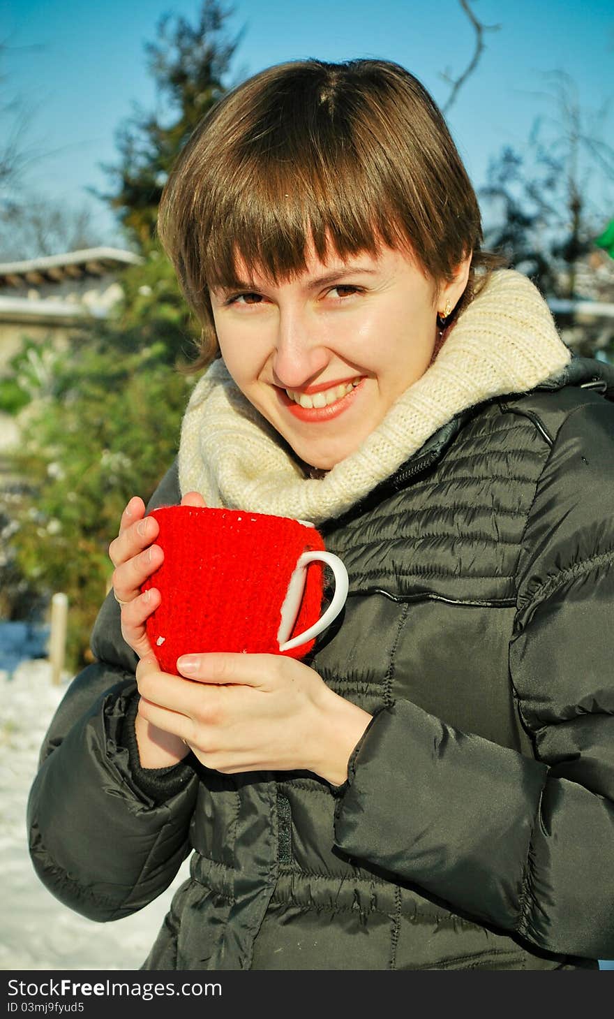 Young woman drinking hot tea outdoors