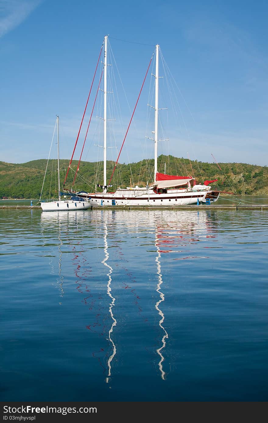 Yacht and boat in the harbor and reflection