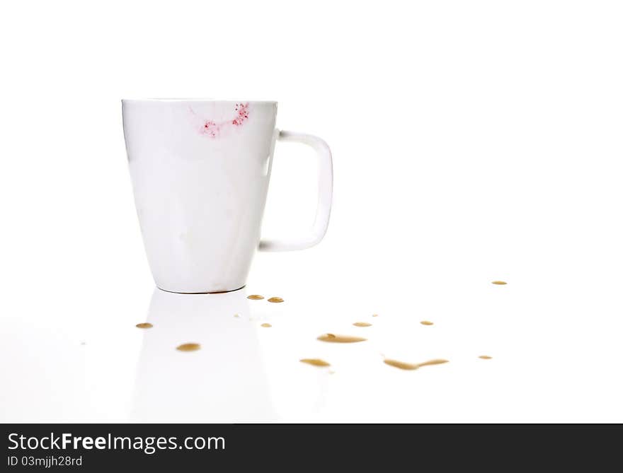 A lipstick mug surrounded with coffee splatters... Isolated!. A lipstick mug surrounded with coffee splatters... Isolated!