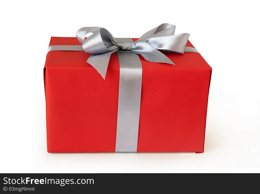 Red gift box with silver ribbon isolated on white