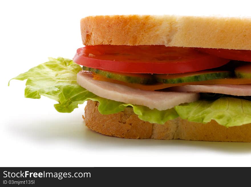 Part of the sandwich. Isolated on white background. Sandwich consists of bread, cucumbers, tomatoes, cheese, ham and greens. Isolated on a white background. Part of the sandwich. Isolated on white background. Sandwich consists of bread, cucumbers, tomatoes, cheese, ham and greens. Isolated on a white background.