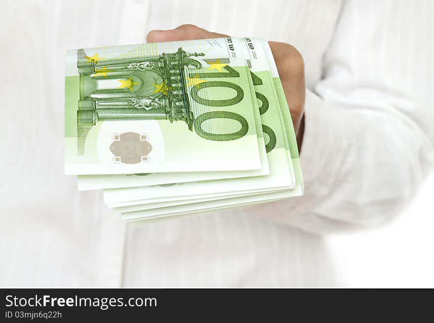 Euro in hand of women on white background