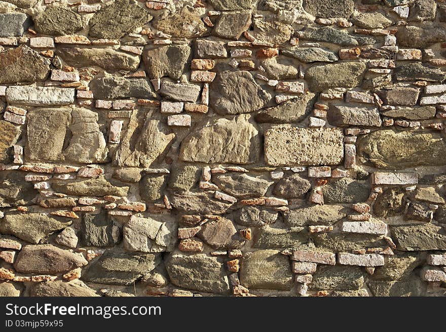 Old stone wall with some bricks in Portugal