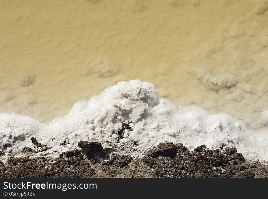 Crystallized salt in an evaporation pond, Algarve, Portugal. Crystallized salt in an evaporation pond, Algarve, Portugal