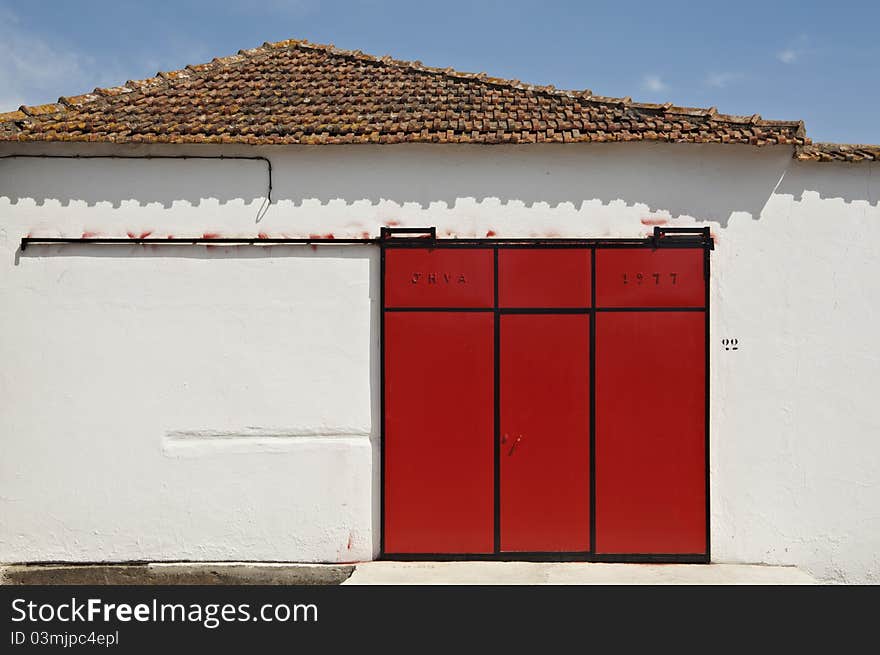 Red sliding gate in a warehouse, Portugal. Red sliding gate in a warehouse, Portugal