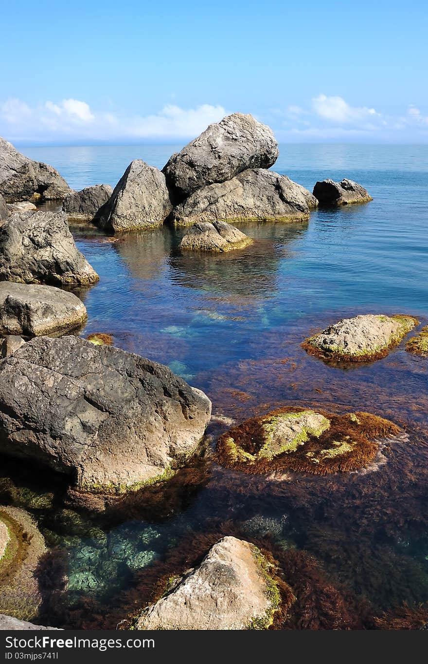 Giant stones in the sea with clouds