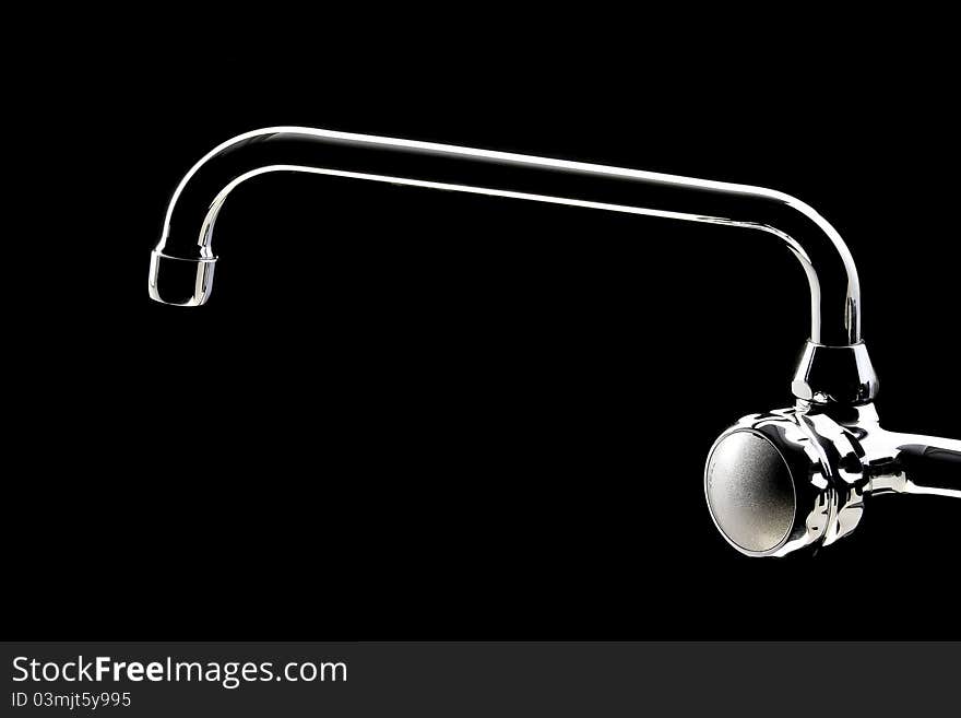 Kitchen faucet in black background