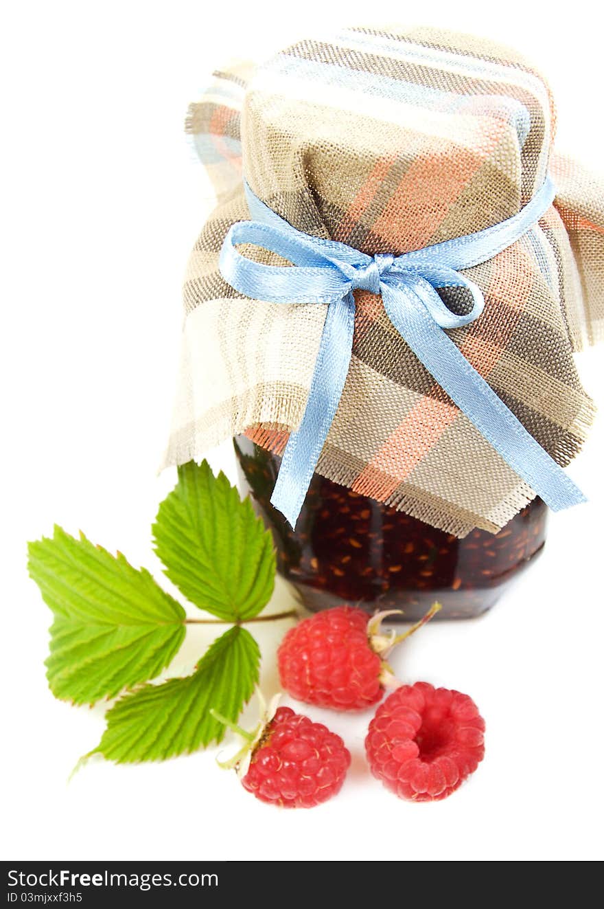 Raspberry jam and fresh raspberries on a white background