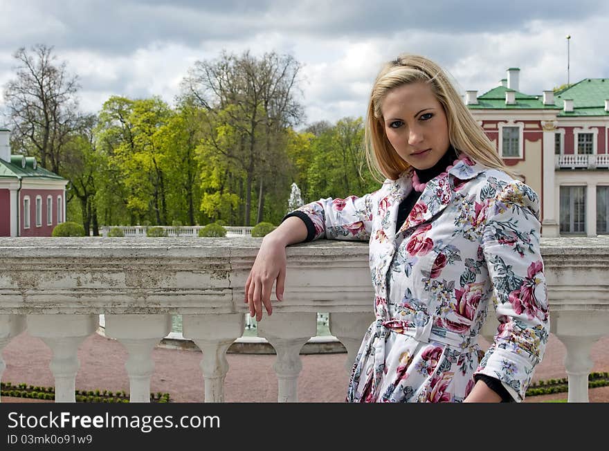 Blonde girl standing against the background of an old palace. Blonde girl standing against the background of an old palace