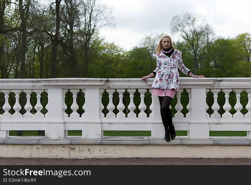 Blonde Girl Is Leaning On Railing