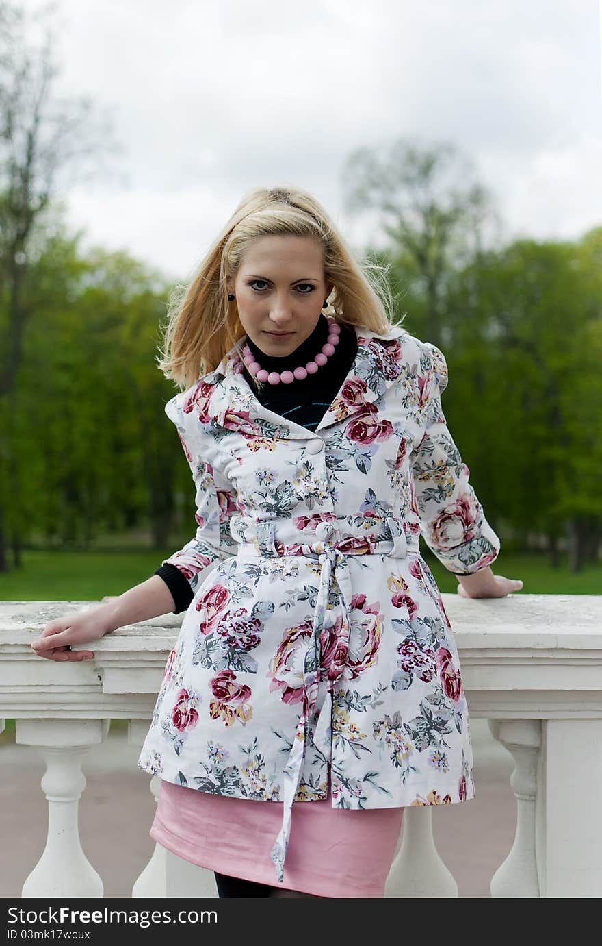 Blonde girl is leaning on railing