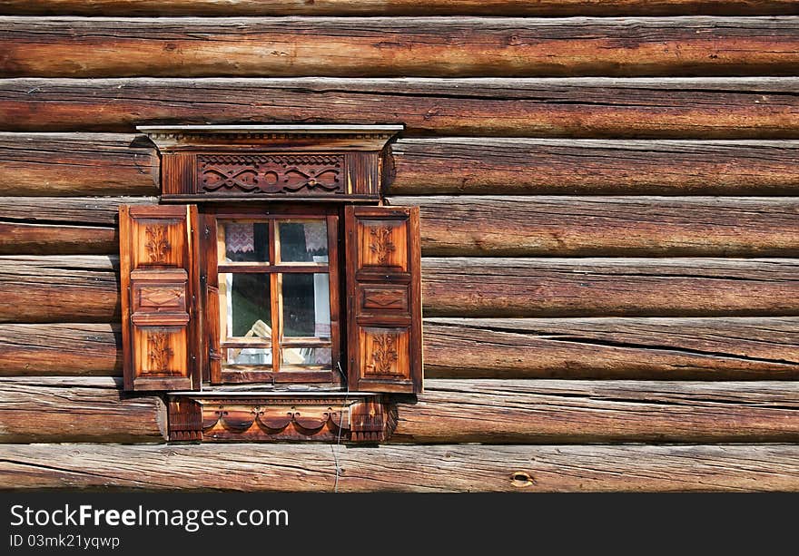 Window in the old wooden house close-up