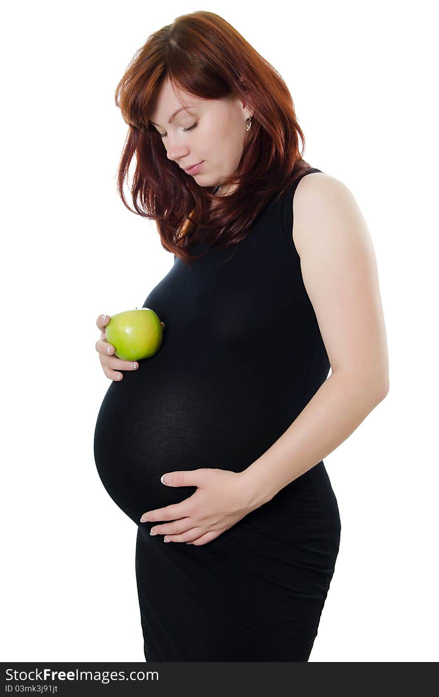 The pregnant woman with an apple isolated on white