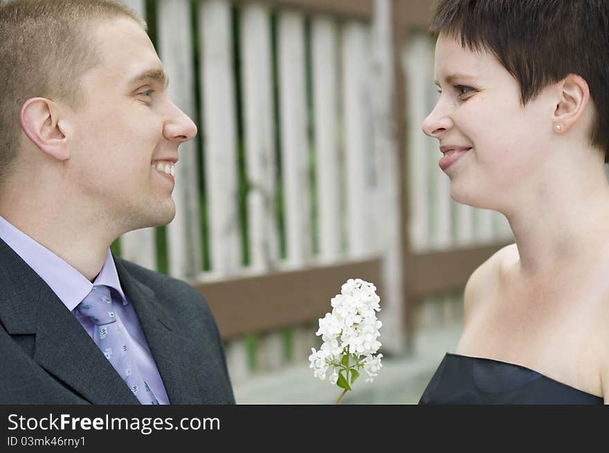 Portrait Of Young Couple Next To The Fence