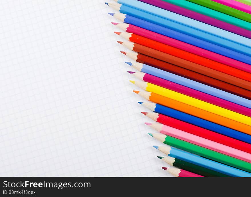 A number of pencils on school writing-book. A number of pencils on school writing-book