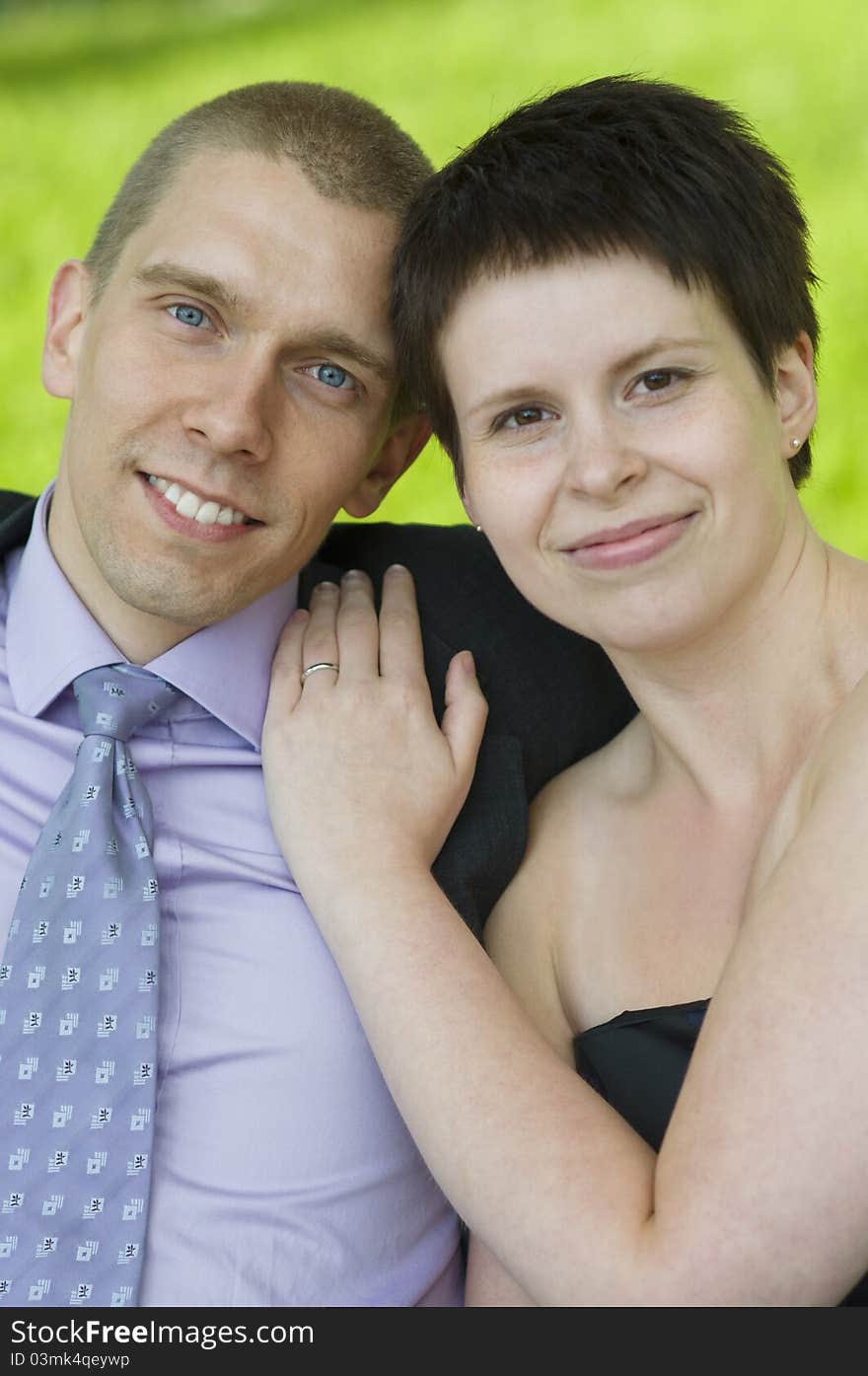 Portrait Of Young Couple On A Park Bench